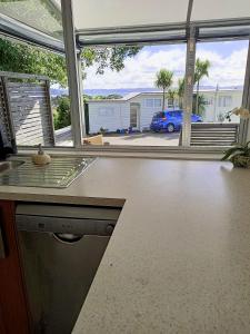 旺阿帕劳阿Adorable Beach Unit Stanmore Bay的一个带柜台的厨房,享有汽车的景色