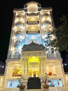 潘切Huy Đạt Hotel的一座大型白色建筑,设有飞镖