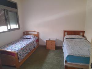 海尼夫拉Appartement ennasr49的一间卧室设有两张床和窗户。