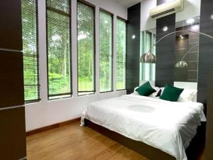 关丹Teluk Cempedak Seventh Haven的一间卧室配有一张带绿色枕头的床和窗户。