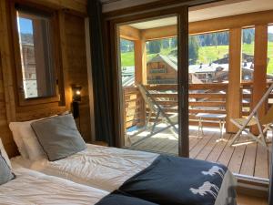 莱热狩猎山酒店的一间卧室配有一张床,享有甲板的景色