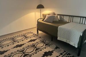 韦默尔斯基兴The Forest Retreat- Luxuriöse Ferienwohnung mit privater Sauna的一间卧室配有一张带地毯和灯的床