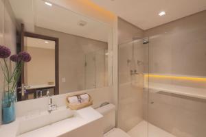 累西腓HY Apartments & Hotels的一间带水槽和玻璃淋浴的浴室