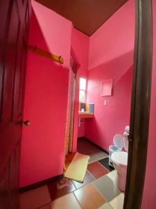 托尔图格罗Hotel Sunset Rooms的一间带粉色墙壁和卫生间的浴室