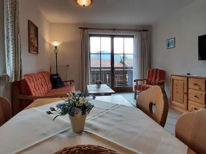 贝里斯泽尔Lovely holiday home in Bayrischzell with sauna的客厅配有沙发和鲜花桌