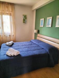 PoggioLa Cerreta Affittacamere的一间卧室配有蓝色的床和2条毛巾
