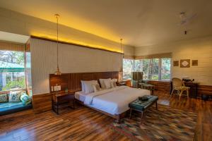 坎哈The Riverwood Forest Retreat - Kanha的一间大卧室,配有一张大床和一张书桌