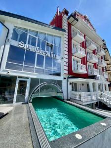 布克维Chevalier Hotel & SPA的大楼前设有游泳池的酒店