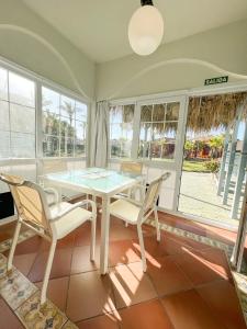 马塔拉斯卡尼亚斯ON Family Playa de Doñana的一间配备有白色桌椅的用餐室