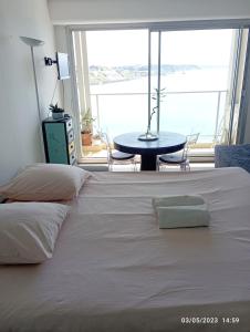 比亚里茨AGTBAB的卧室配有一张白色的床、桌子和窗户。