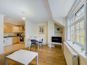 红山Duplex Redhill town centre Apt by Livingo Stays的厨房以及带桌椅的起居室。