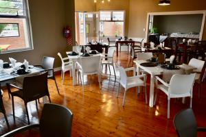 斯瓦科普蒙德The Mole Guesthouse的用餐室配有白色的桌子和白色的椅子