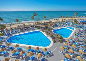 贝纳尔马德纳日落海滩俱乐部公寓酒店的享有度假村游泳池和海洋的空中景致