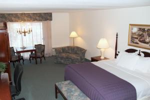 格林里弗河流露台酒店的酒店客房带一张床、一张桌子和椅子