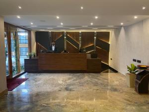 班加罗尔Royal Ace Boutique Hotel - Manyata Techpark的坐在大堂桌子上的男人