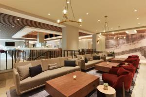 圣克拉拉广场套房酒店的一个带沙发和桌子的大堂和一间酒吧