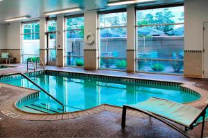 查尔斯湖查尔斯湖万豪春季山丘套房酒店的一座大型游泳池,位于一座带窗户的建筑内