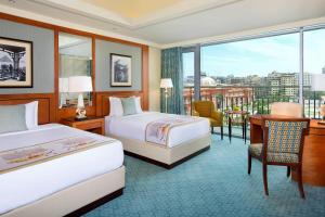 开罗开罗尼罗河丽思卡尔顿酒店集团的酒店客房设有两张床、一张书桌和一个窗户。