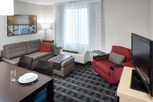 哥伦比亚哥伦比亚东南/福特杰克逊万豪广场套房酒店.的客厅配有沙发、椅子和电视