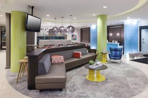 奥兰多万豪奥兰多海洋世界春山套房酒店的大厅配有沙发和电视。