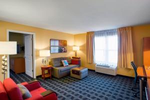 欧弗兰帕克堪萨斯城欧弗兰帕克万豪广场套房酒店的酒店客房,配有沙发和椅子