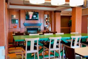 埃姆斯艾姆斯费尔菲尔德套房酒店的一间带绿色桌椅的用餐室