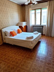 泰塞拉Locazione Turistica的一间卧室配有一张带橙色枕头的大床