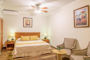 利马安提瓜米拉弗洛雷斯酒店的一间卧室配有一张床和两把椅子