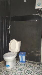 阿普春安Amikaje Farm的一间带卫生间和黑色墙壁的浴室