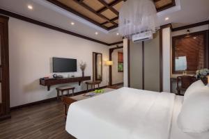 Pu LuongEBINO PULUONG RESORT的卧室配有一张白色大床和一张书桌