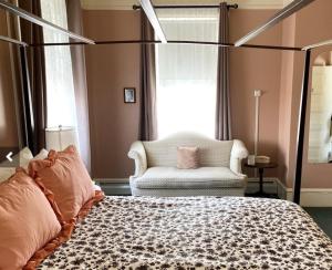 Brandon布兰登酒店的一间卧室配有一张床、一张沙发和一把椅子