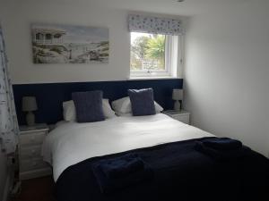 LlangoedGwyndaf Holiday Cottage的卧室配有白色的床和窗户。