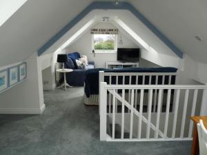 LlangoedGwyndaf Holiday Cottage的阁楼间 - 带床和沙发