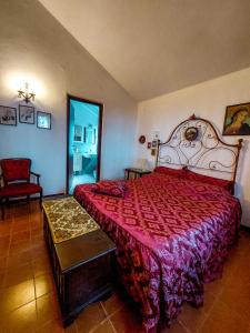 塞尔苏里格La Casa di Cesarina的一间卧室配有一张大床和红色的床罩