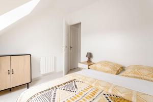 摩兰吉斯Joli appartement proche Paris Orly的白色卧室设有一张大床和一个梳妆台