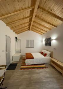 帕雷迪什迪科拉Casinha Rubiães的一间卧室设有床铺和木制天花板