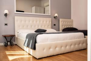 博洛尼亚科斯莫伊B＆B酒店的一张大白色的床,位于带镜子的房间里