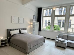 莱比锡MEOS 2 -Zentrum-Hofblick-Gym-Netflix的一间卧室配有一张床、一把椅子和窗户。
