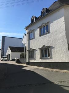 埃特灵恩Ferienwohnung Backes的白色的建筑,在街上有两扇窗户