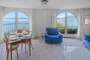 圣金戈尔夫Splendide logement avec vue plongeante sur le lac的客厅配有桌子和蓝椅