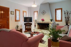 KhlóïNorma’s House的客厅配有粉红色的椅子和壁炉