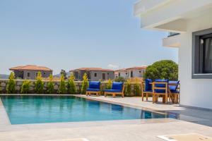 阿拉恰特Amazing Villa with Private Pool in Alacati Cesme的别墅 - 带游泳池和蓝色椅子