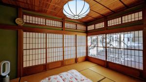 富士吉田市富士吉田かつまたや的客房设有窗户、一张床和闹钟