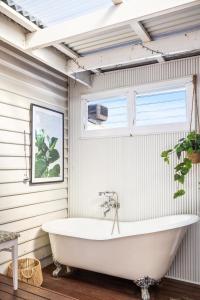 弗里曼特All Decked Out, Fremantle的带窗户的浴室内的白色浴缸