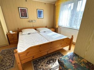滨湖克拉科Ferienhaus Krakow am See SEE 7981的一间卧室设有一张大型木床和一个窗户。