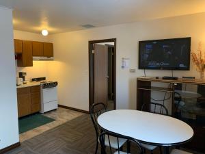 怀特霍斯Destination Family Hotel的小厨房配有桌子和墙上的电视。