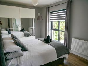 威克洛Entire Modern Home with seaview and parking的一间卧室设有两张床和大镜子