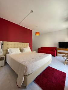 米尔芳提斯城Só Mar的卧室配有白色的床和红色的墙壁