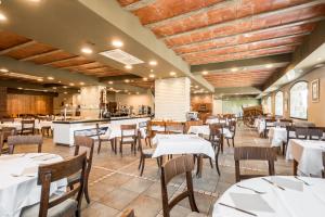 福米加尔Snö Villa de Sallent 3的餐厅设有白色的桌椅和柜台
