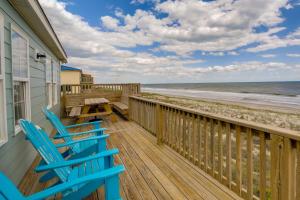 翡翠岛Beachfront Emerald Isle Vacation Rental with Deck!的一个带两把椅子和一张桌子的甲板和海滩